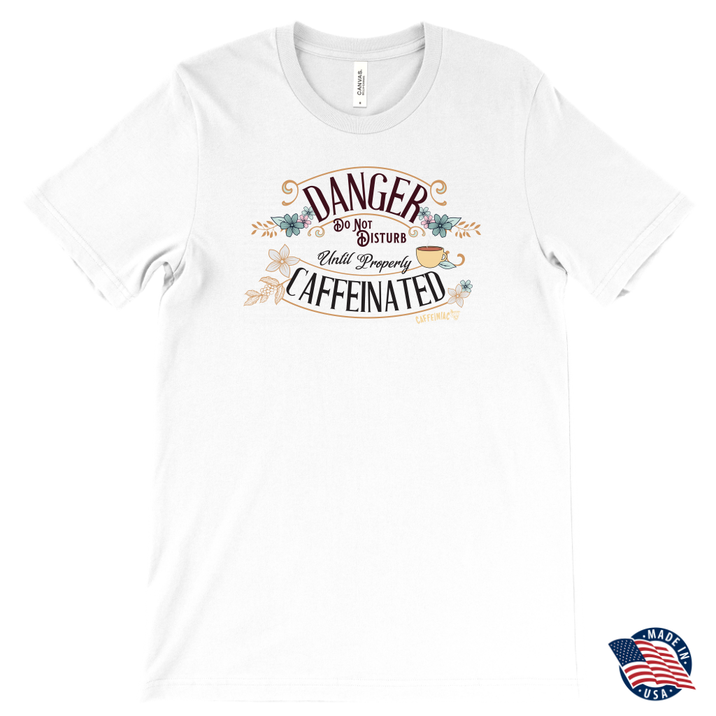 a men's white t-shirt featuring the Caffeiniac design "Danger Do Not Disturb Until Properly Caffeinated".