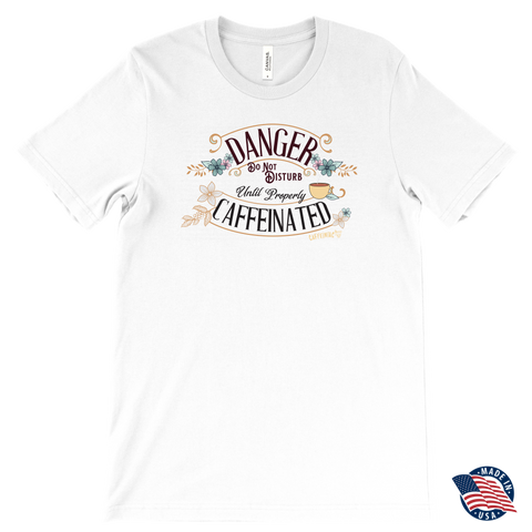 Image of a men's white t-shirt featuring the Caffeiniac design "Danger Do Not Disturb Until Properly Caffeinated".