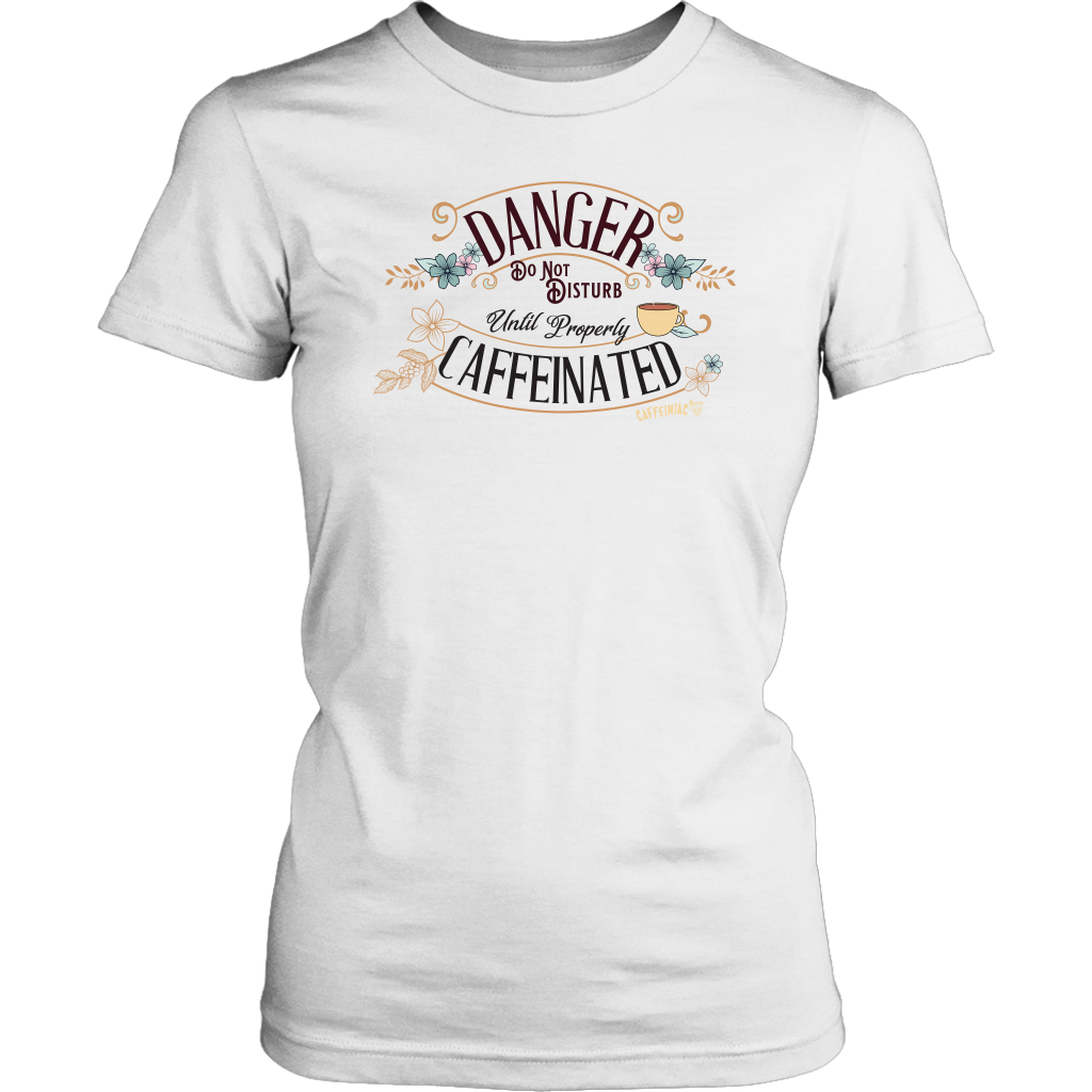 a women's white t-shirt featuring the Caffeiniac design "Danger Do Not Disturb Until Properly Caffeinated".