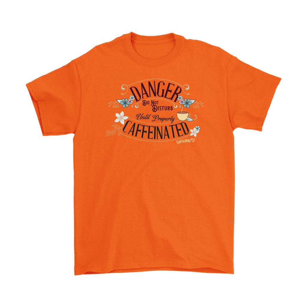 a men's orange t-shirt featuring the Caffeiniac design "Danger Do Not Disturb Until Properly Caffeinated".