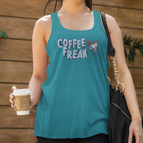 Image of woman holding a cup of coffee wearing a teal Caffeiniac tank top with the COFFEE FREAK design in light blue letters