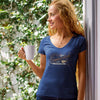 a woman on a patio wearing a navy blue v-neck shirt with the coffee connoisseur design by caffeiniac