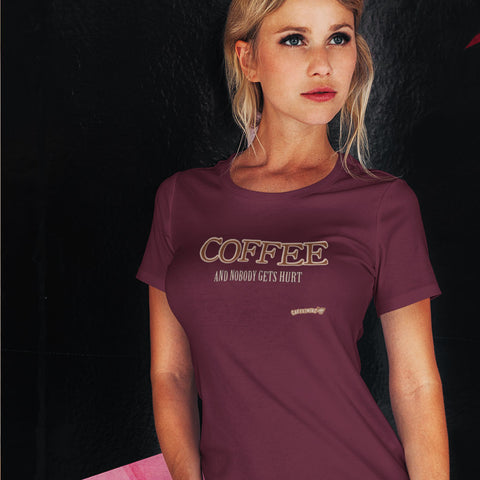 Image of Woman standing wearing a purple shirt featuring the Caffeiniac design "Coffee and nobody gets hurt" on the front