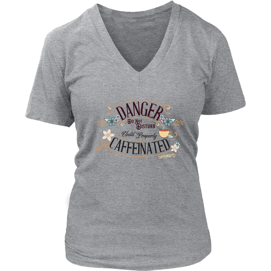 a women's light grey v neck t-shirt featuring the Caffeiniac design "Danger Do Not Disturb Until Properly Caffeinated".