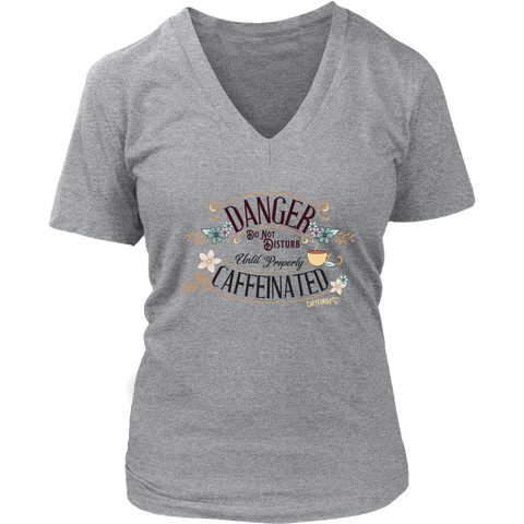 Image of a women's light grey v neck t-shirt featuring the Caffeiniac design "Danger Do Not Disturb Until Properly Caffeinated".