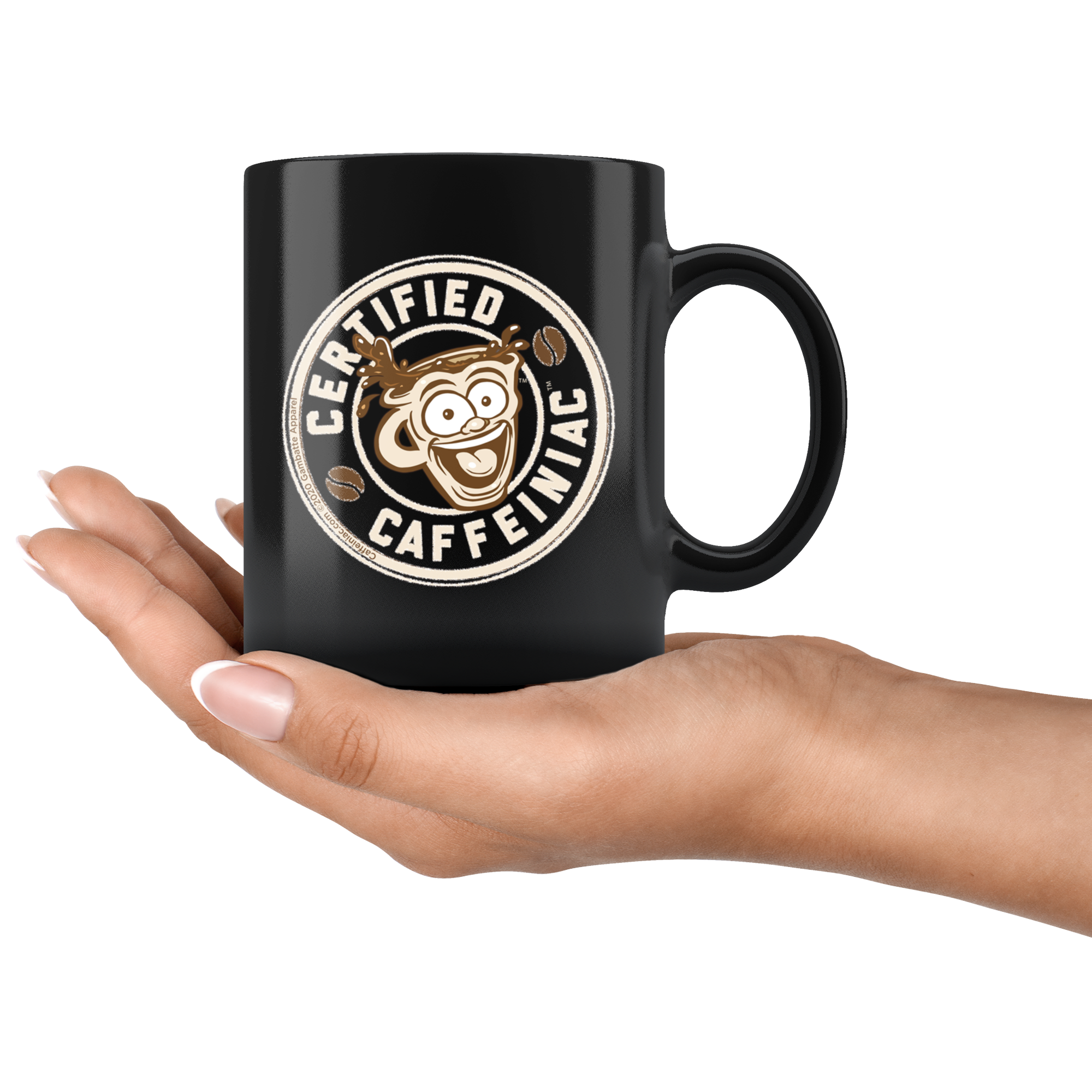 a black coffee mug featuring the Certified Caffeiniac design in tan and brown printed on the front and back resting on a woman's palm