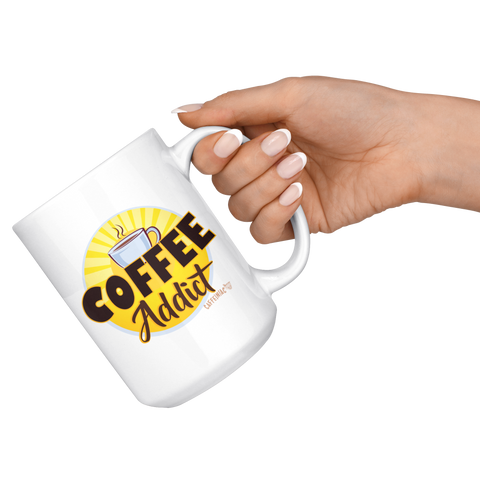 Image of a hand holding  a white ceramic coffee mug with a vibrant Caffeiniac design " Coffee Addict"