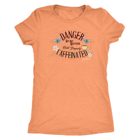Image of a women's soft orange tee featuring the Caffeiniac design DANGER do not disturb until properly caffeinated