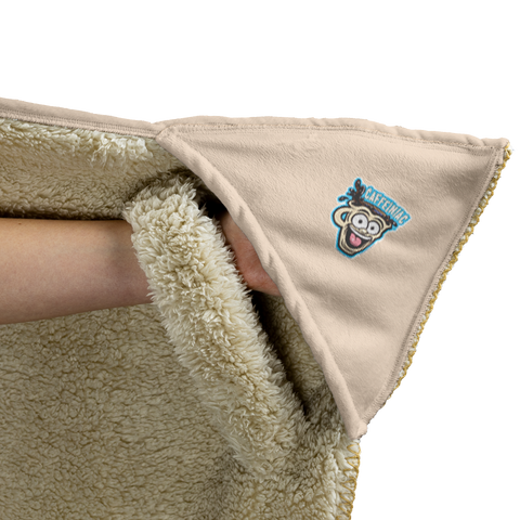 Image of the left glove area of a fleece lined hooded blanket with the Caffeiniac Dude logo on the glove