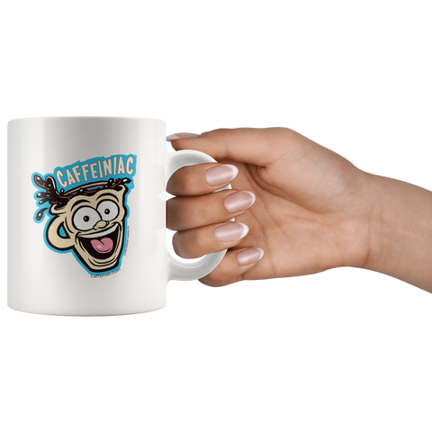 Image of a woman's hand holding the handle of a white ceramic coffee mug with a vibrant Caffeiniac design which is printed on both sides