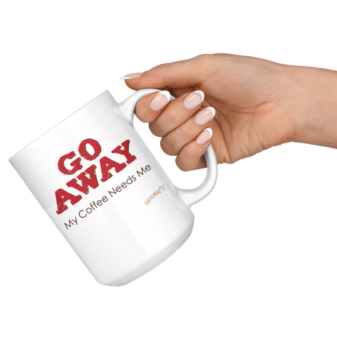 Image of a hand holding a white ceramic coffee mug by the handle with the Caffeiniac design GO AWAY My Coffee Needs Me on both sides