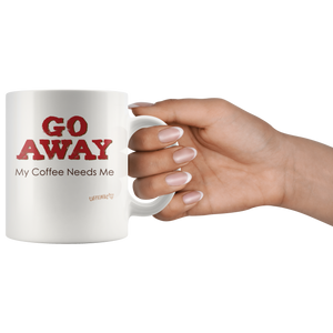 a womans hand holding the handle of a white ceramic coffee mug with the Caffeiniac design GO AWAY My Coffee Needs Me on both sides