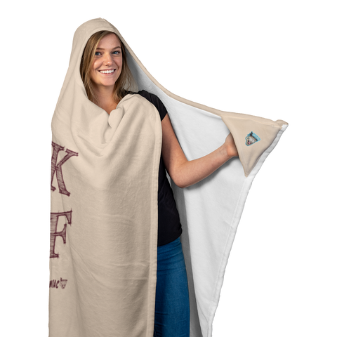 Image of woman holding the left glove areas of a  luxurious hooded blanket featuring the Caffeiniac design F_CK DECAF