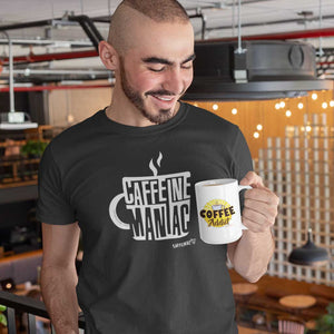 man enjoying a cup of coffee wearing a grey Caffeiniac t-shirt featuring the Caffeine Maniac design on the front in white letters