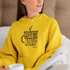 woman wearing a yellow hoodie by Caffeiniac featuring the design CAFFEINE MANIAC on the front