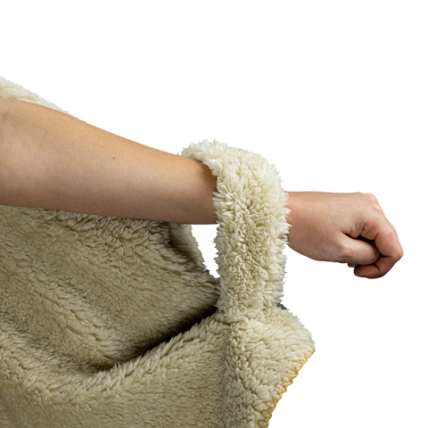 Image of a woman's arm with the soft fleece loop of the hooded blanket to hold the left side in place 