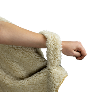 a woman's arm with the soft fleece loop of the hooded blanket to hold the left side in place 