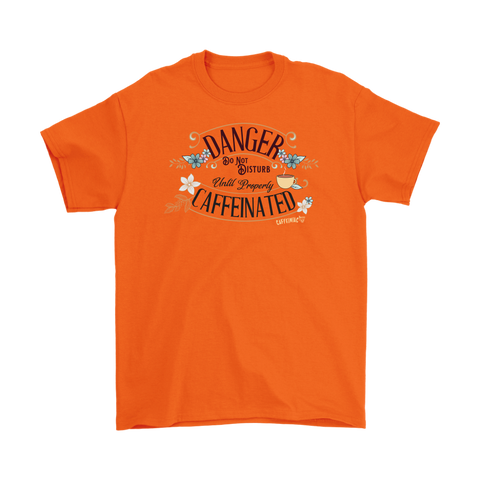 Image of a men's orange t-shirt featuring the Caffeiniac design "Danger Do Not Disturb Until Properly Caffeinated".