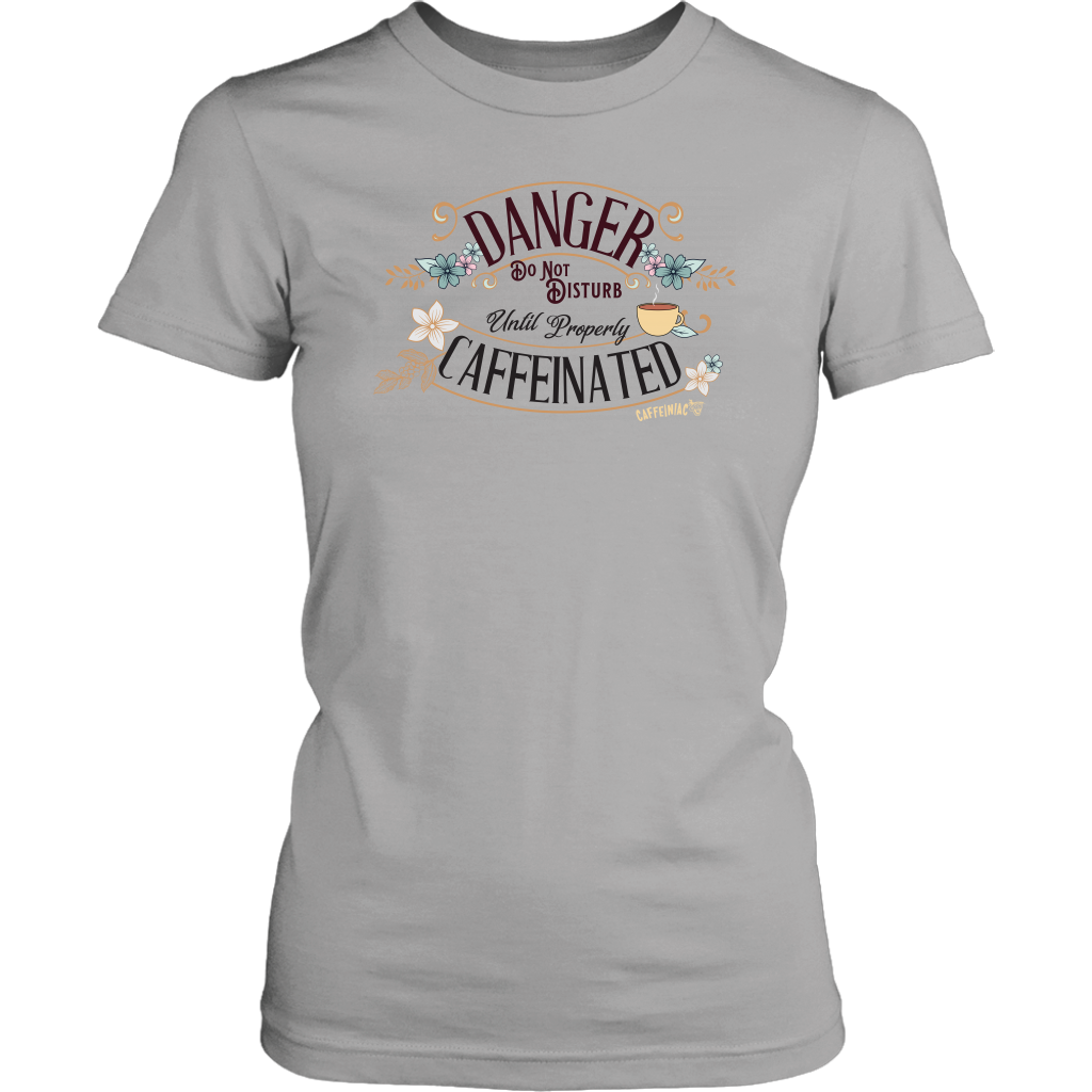a women's light grey t-shirt featuring the Caffeiniac design "Danger Do Not Disturb Until Properly Caffeinated".