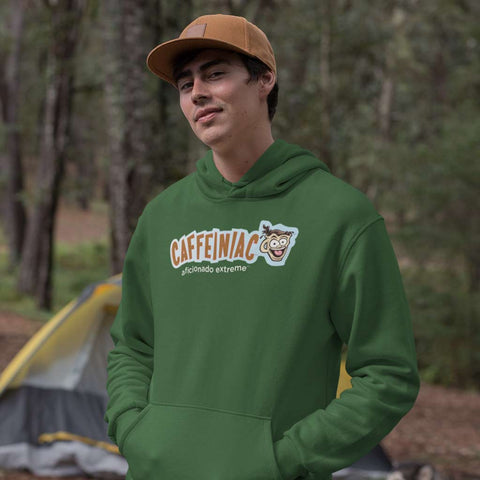 Image of man standing in the woods wearing a green hoodie featuring the caffeiniac aficionado extreme design on the front