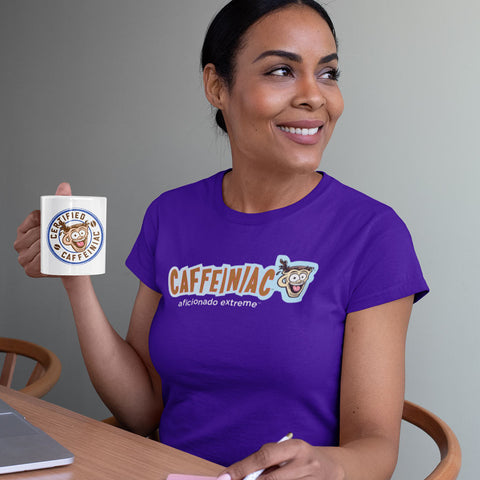 Image of Woman drinking coffee at her desk wearing a purple t-shirt featuring Caffeiniac Aficionado Extreme design 