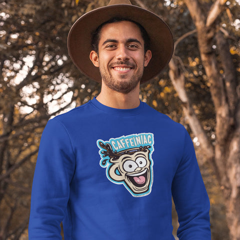 Image of man standing in the woods wearing a hat and a navy blue crewneck sweatshirt featuring the original Caffeiniac Dude cup design