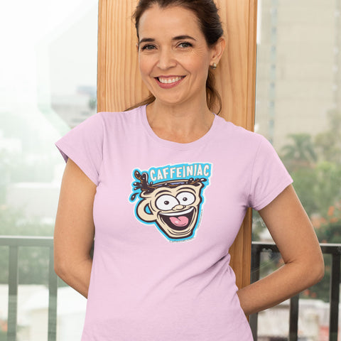 Image of Woman standing against wall wearing a pink short sleeve shirt featuring the original Caffeiniac dude cup design on the front