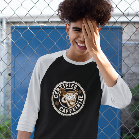 Image of smiling young man wearing a black raglan shirt with light grey sleeves featuring the Certified Caffeiniac design on the front
