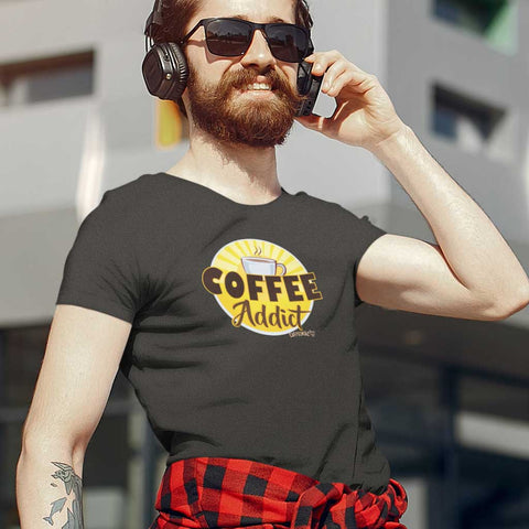 Image of a man on his phone wearing a dark grey Caffeiniac t-shirt featuring the Coffee Addict design on the front