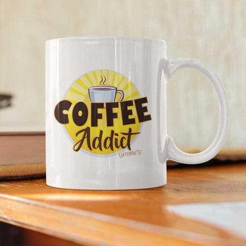 Image of A white ceramic 15oz coffee mug with the Caffeiniac design COFFEE Addict on the front and back