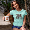 smiling woman wearing a caffeiniac coffee obsessed shirt