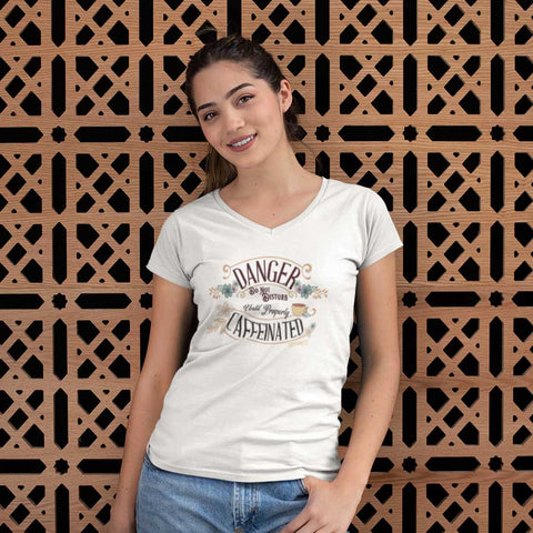 Image of woman wearing a white v-neck t-shirt featuring the Caffeiniac design DANGER do not disturb until properly caffeinated