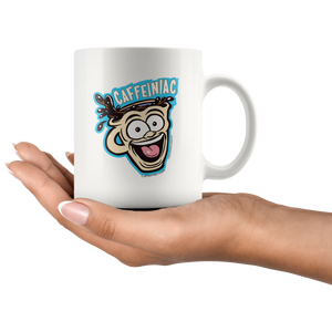 a woman's hand holding a white ceramic coffee mug with a vibrant Caffeiniac design which is printed on both sides