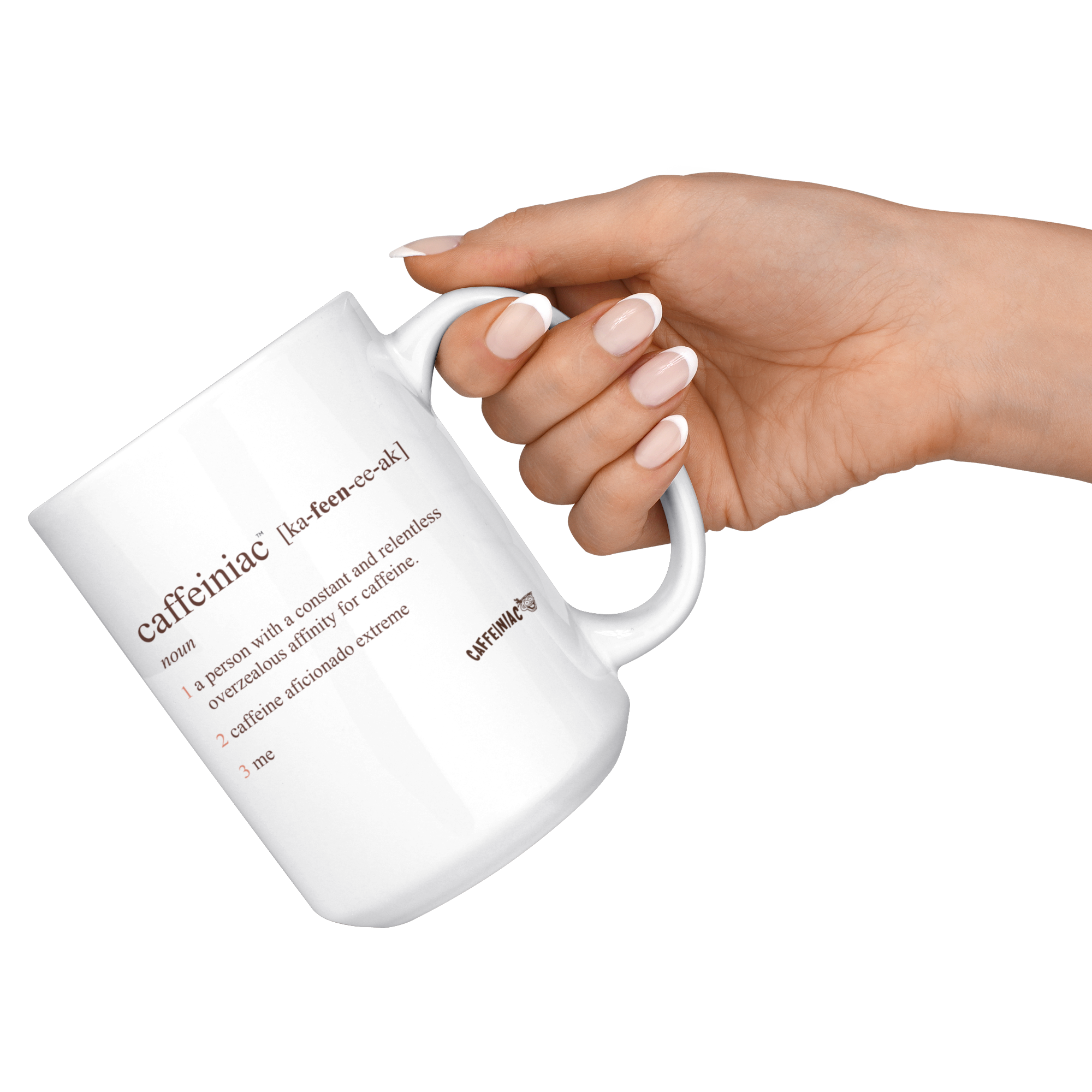 a womans hand with a French manicure holding a white coffee mug with the original Caffeiniac defined design in brown ink