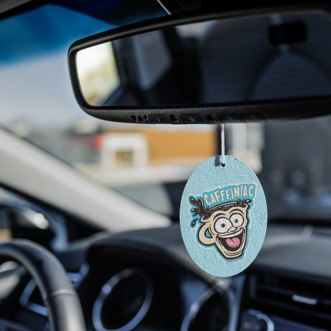 Image of Caffeiniac Dude air freshener hanging from a car's rear view mirror 