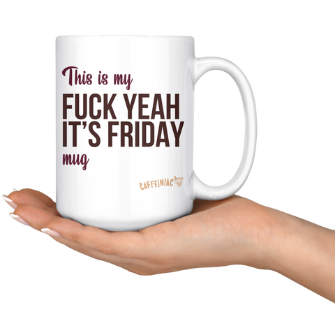 Image of a hand holding a white ceramic mug that says This is my fuck yeah it's friday mug