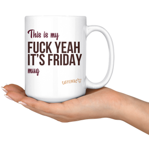 a hand holding a white ceramic mug that says This is my fuck yeah it's friday mug