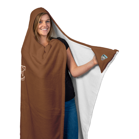 Image of a woman wearing a soft hooded blanket holding the left corner to display thee Caffeiniac Dude logo