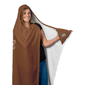 a woman wearing a soft hooded blanket holding the left corner to display thee Caffeiniac Dude logo