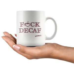 a woman's hand holding a white 11oz coffee mug featuring the Caffeiniac F_CK DECAF design on front and back.