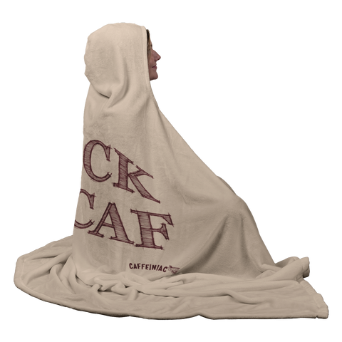 Image of smiling woman sitting wearing a luxurious hooded blanket featuring the Caffeiniac design F_CK DECAF